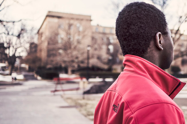 Black man in a red jacket outside