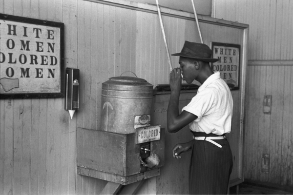 Black man drinking water at a 