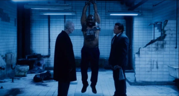 Jigsaw and Detective Hoffman with bound black man